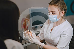 Doctor selects a hearing aid for patient