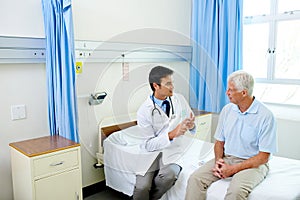 Doctor, senior man patient and speaking with advice, explain or listen to news of health progress in clinic. Men, medic