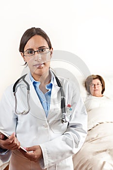 Doctor with senior patient in Background