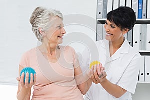 Doctor with senior patient using stress buster balls