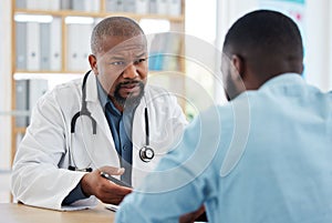 Doctor, serious black man and patient consultation in hospital for talking, checkup or results. Healthcare, medical