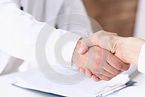 Doctor shake hand as hello with patient