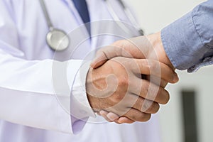 Doctor shakes hands with a patient