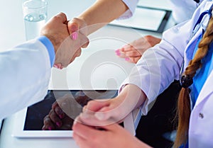 Doctor shakes hands with a patient isolated on white background