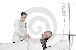 Doctor shaking hand with elderly patient