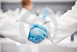 Doctor, shaking hands and gloves for safety in healthcare, partnership or trust for collaboration, unity or support at