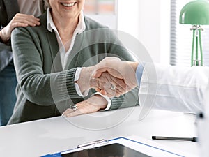 Doctor shaking hands with a senior patient