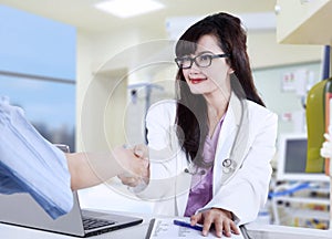 Doctor shaking hands to patient