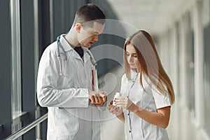 Doctor is sharing pills in hands to another doctor photo