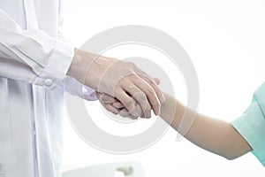 The doctor shook the patient`s hand to give encouragement in the fight against disease.