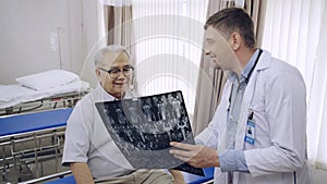 Doctor show Film X-ray for a patient at hospital. Body scan after surgery and operate. Health