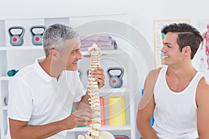 Doctor showing anatomical spine to his patient