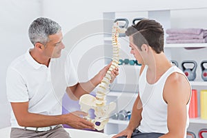 Doctor showing anatomical spine to his patient