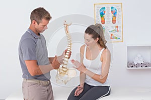 Doctor showing anatomical spine to his patient