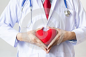 Doctor showing compassion and support holding red heart