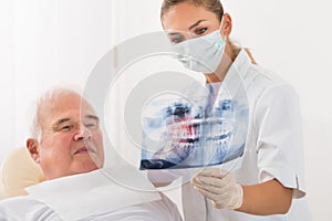 Doctor Showing Dental X-ray To Male Patient