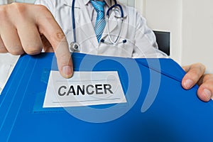 Doctor is showing folder with cancer diagnosis photo