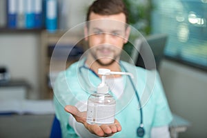 Doctor showing hand sanitizer photo