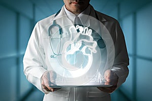 Doctor showing heart hologram from computer.