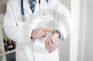 Doctor showing his watch with his finger