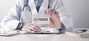 Doctor showing Hypnose word on business card