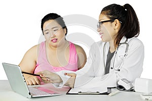 Doctor showing medical result to her fat patient