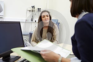 Doctor Showing Patient Test Results On Digital Tablet photo