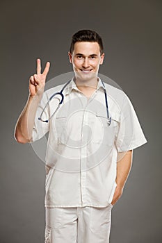 Doctor showing peace sign or number two