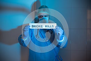 Doctor showing a poster against smoking and nicotine, a way to prevent smoking that is very harmful to health and causes cancer.