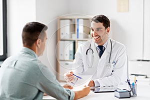 Doctor showing prescription to patient at hospital