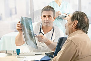 Doctor showing x-ray image to patient