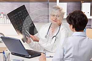 Doctor showing x-ray results to patient