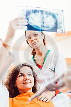 Doctor showing x-ray to patient