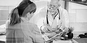 Doctor showing reports on digital tablet to his female patient, geometric pattern