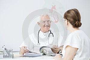 Doctor showing sanatorium brochures photo