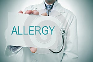 Doctor showing a signboard with the word allergy