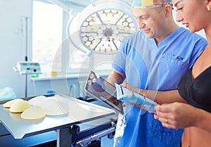 Doctor showing young patient her chest in his office at the hospital