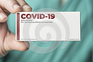 Doctor shows a box of coronavirus covid-19 antiviral pills photo