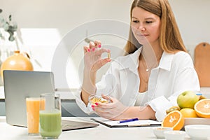 Doctor shows a capsule with vitamin D, omega 3 to a patient during an online consultation. Telemedicine.