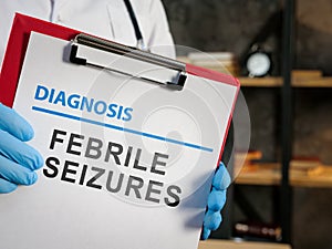 Doctor shows diagnosis febrile seizures on the medic form. photo