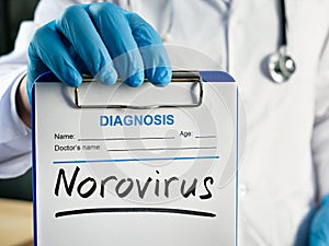The doctor shows the diagnosis norovirus on the form.
