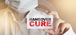 Doctor shows Hangover cure text on card. Alcohol addiction concept