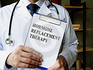 Doctor shows Hormone replacement therapy HRT information. photo