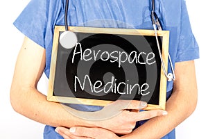Doctor shows information on blackboard: aerospace medicine.  Medical concept