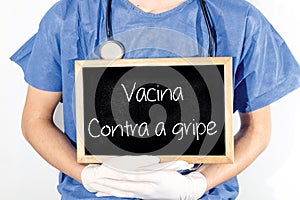 Doctor shows information on blackboard: phobiam flu shot in portuguese.  Medical concept photo