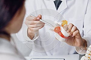 Doctor shows intervertebral hernia to a patient photo
