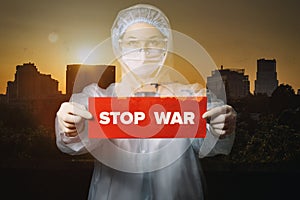 Doctor shows a sign with the inscription stop war