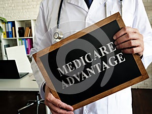 A Doctor shows a tablet Medicare advantage.