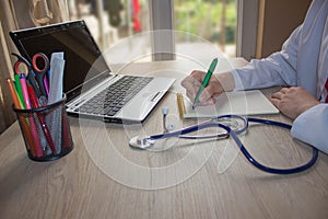 Doctor sitting at the desk near window. Medicine doctor`s workin