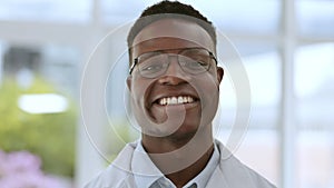 Doctor smile, black man face and proud in a medical, healthcare and wellness hospital. Professional portrait, happiness